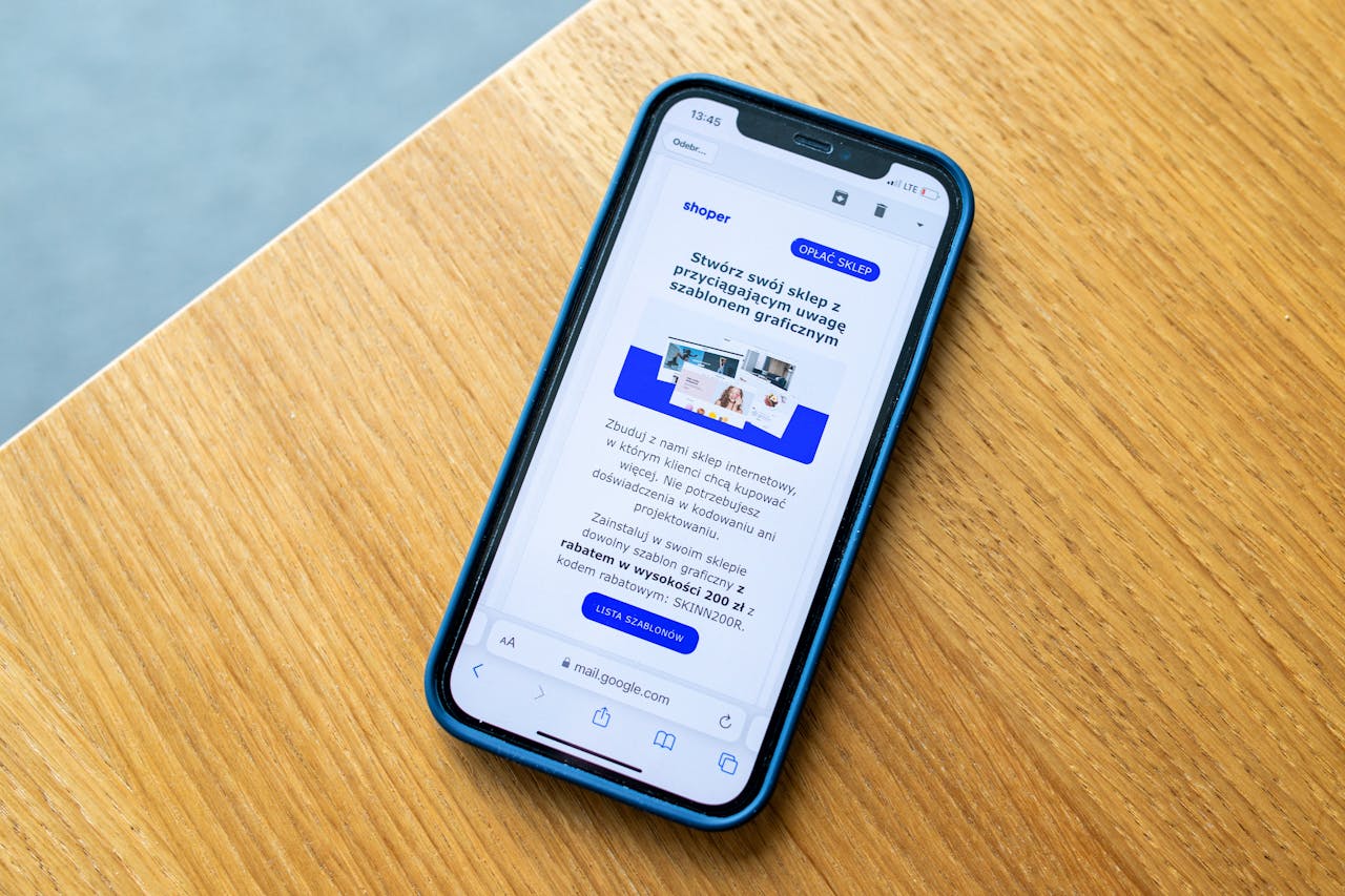 Services Smartphone displaying e-commerce advertisement on wooden surface, ideal for digital marketing themes.