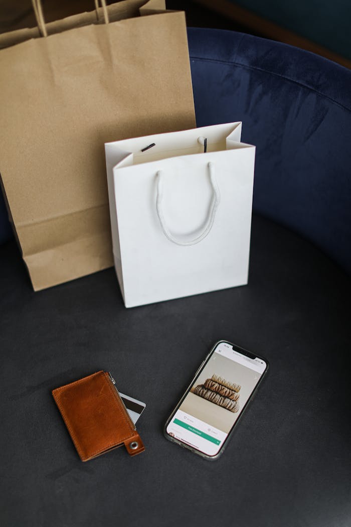 Modern online shopping setup with bags and smartphone.